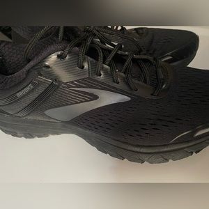 Black on black Brooks running tennis athletic shoes